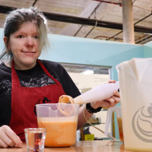 Sally Kuhn Dragon Craft making soap with logo in photo